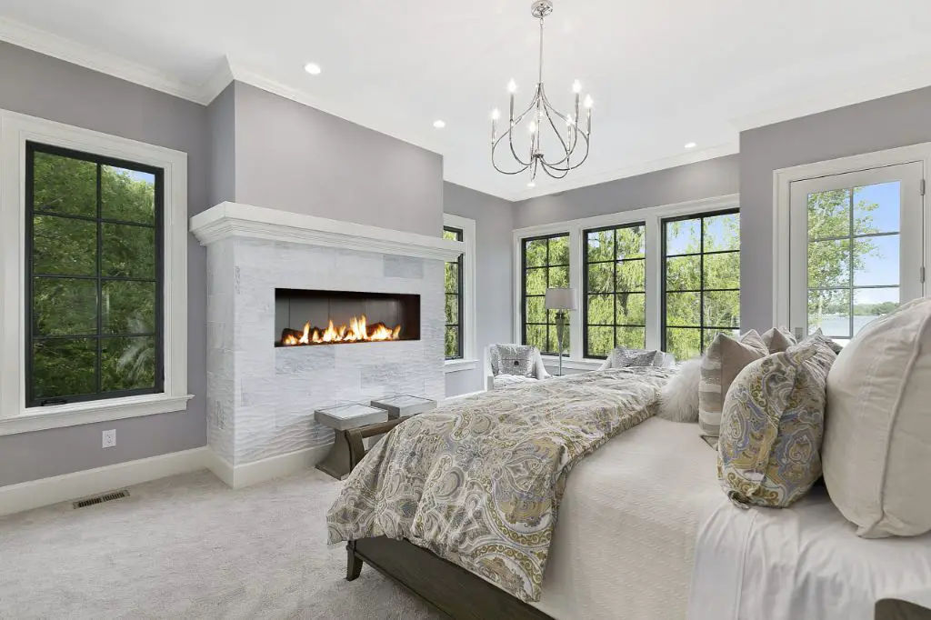 a bedroom fireplace provides charming ambiance and warmth.