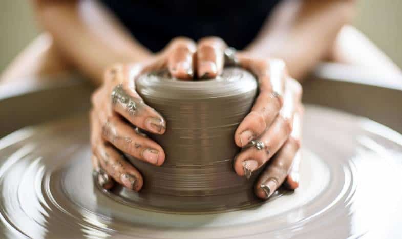 a beginner potter working on a wheel