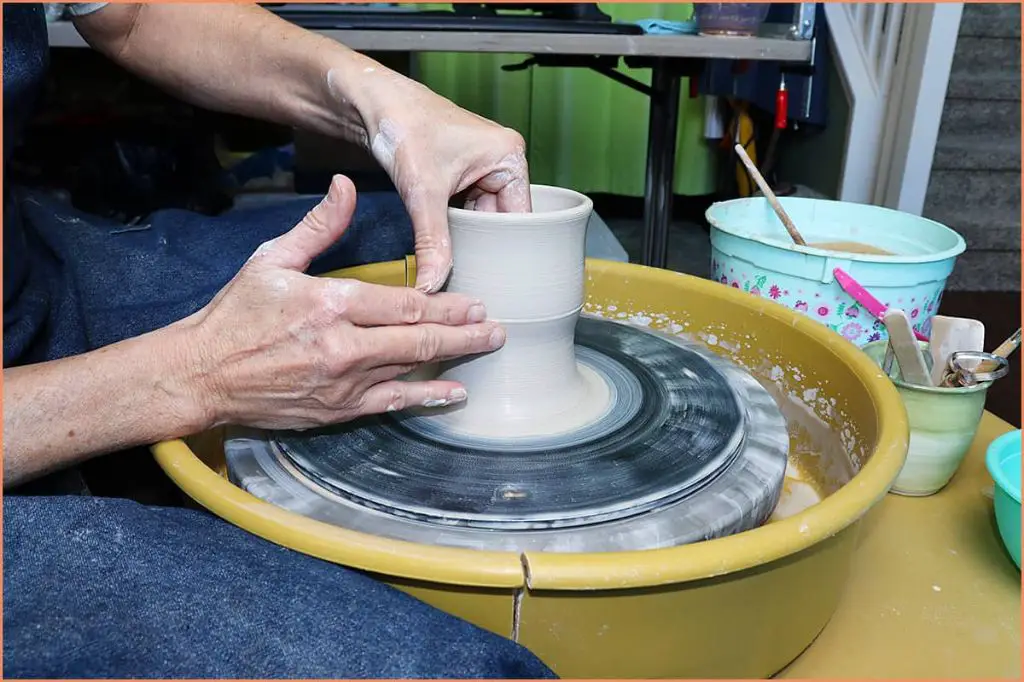 a beginner working on a pottery wheel