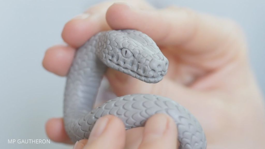 a clay sculpture with detailed reptile scales texture