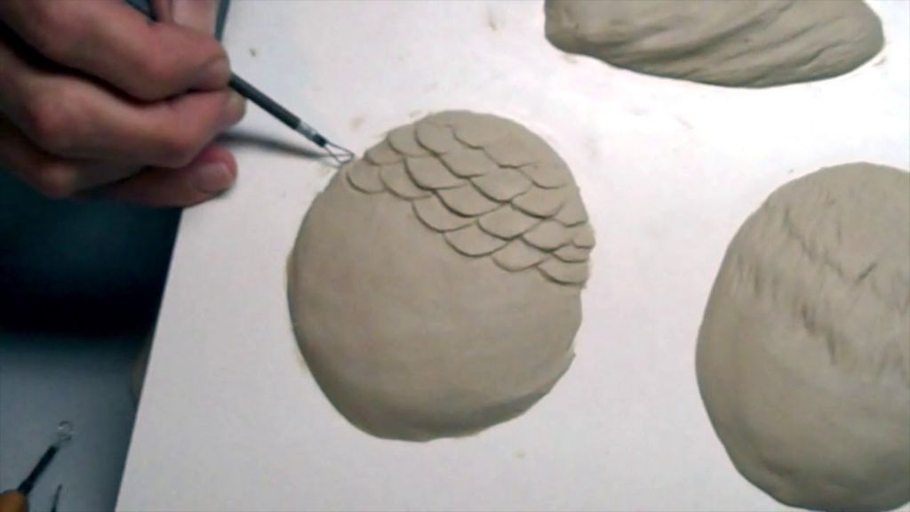 a clay sculpture with engraved and sculpted textures