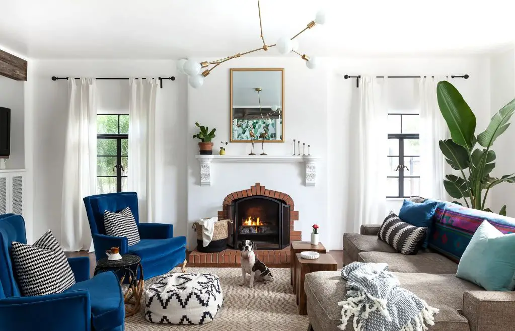 a cozy living room with a stone fireplace and furnishings styled in an inviting manner