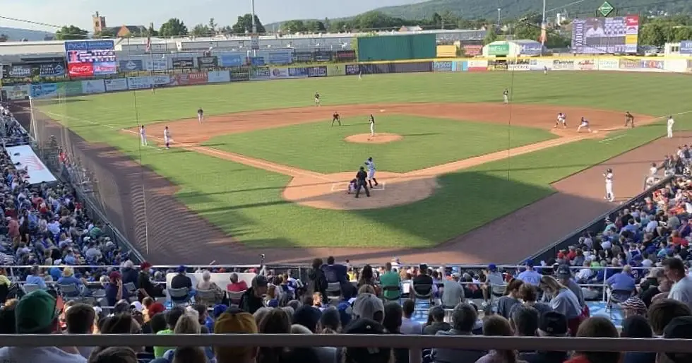 a crowd cheering on the binghamton rumble ponies minor league baseball team playing at nyseg stadium in downtown binghamton.