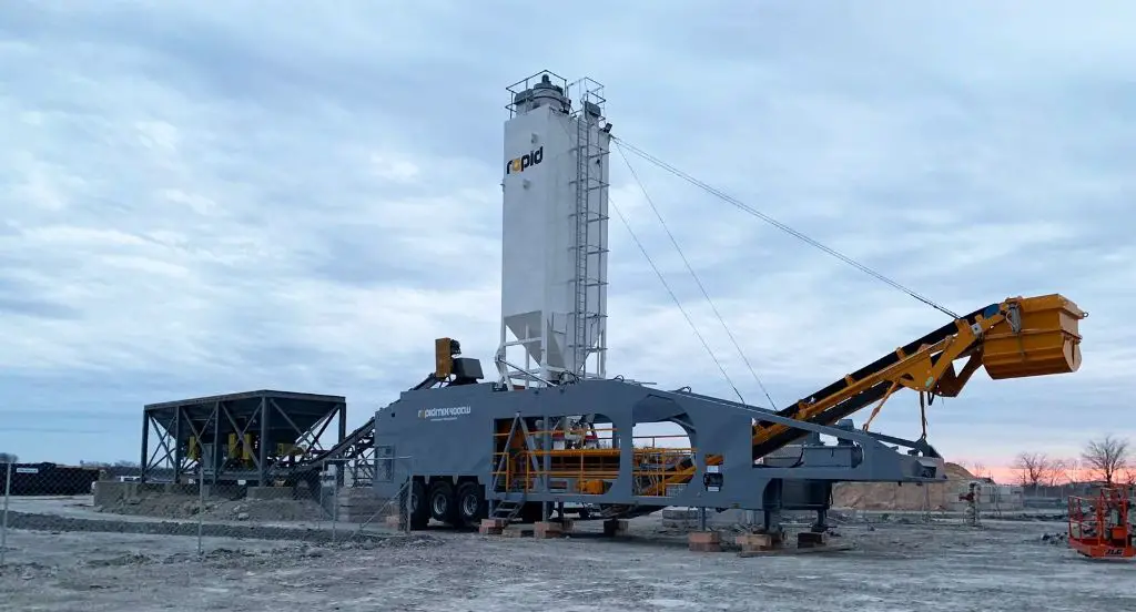 a large industrial pug mill used in a concrete production plant to blend cement, aggregates, and water.