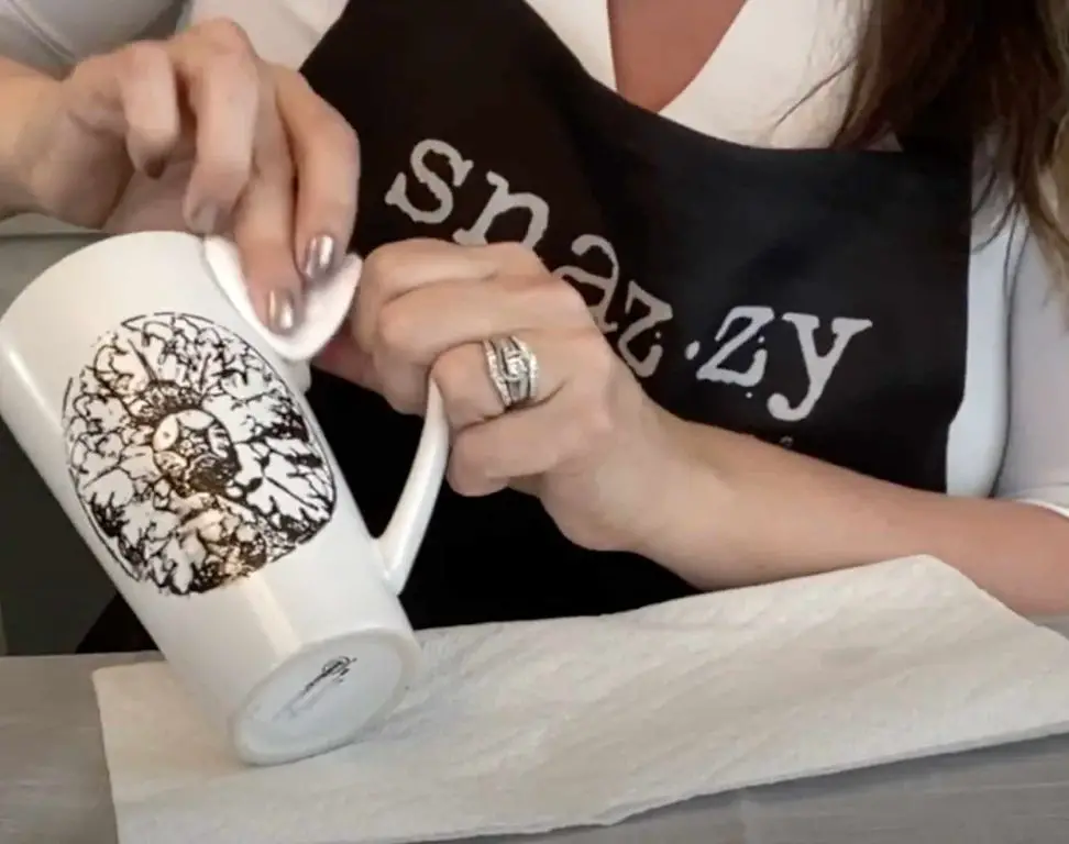 a painted mug sitting on a table drying