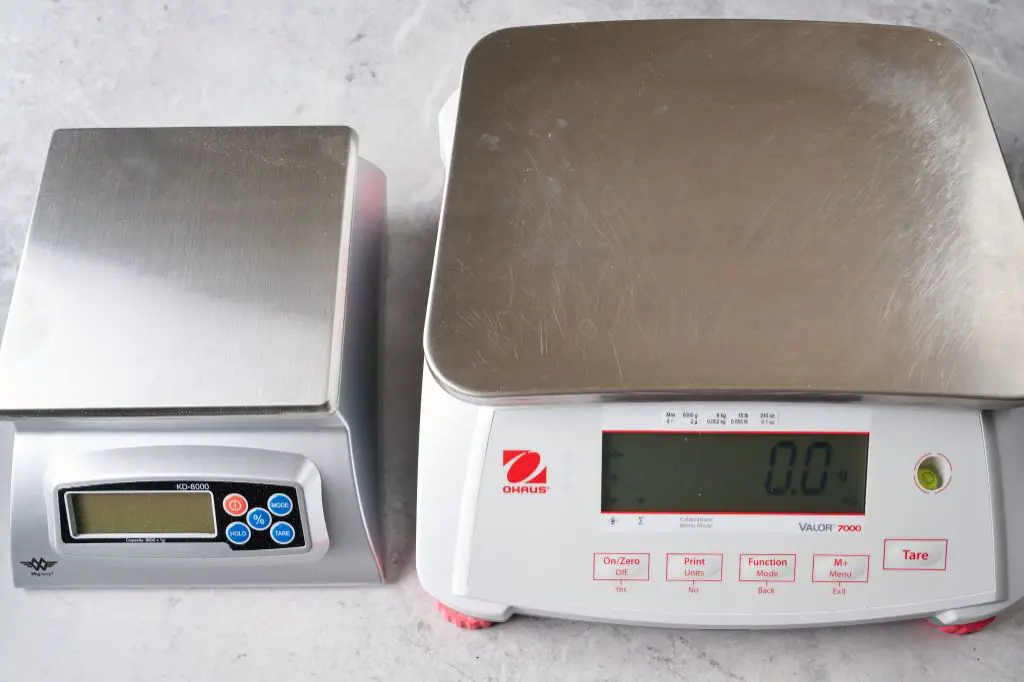 a photo of an ohaus digital kitchen food scale being used to weigh ingredients