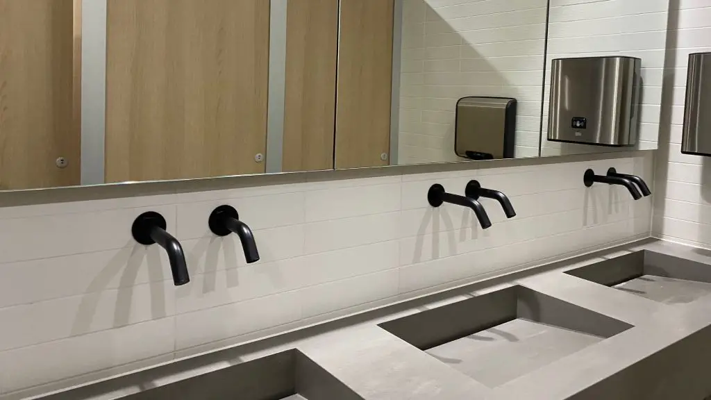 a photo showing touchless soap dispensers in a public restroom