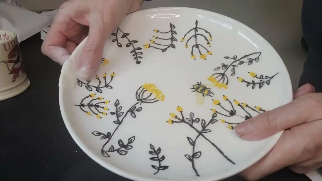 a porcelain plate with a small chip repaired using a paint pen to match the decoration, demonstrating a way to repair minor chips.