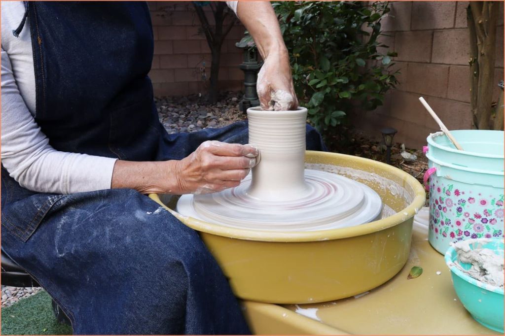 a pottery wheel being used to shape wet clay