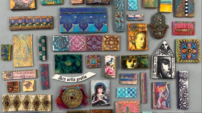 a selection of handmade polymer clay tiles arranged together into a mosaic artwork