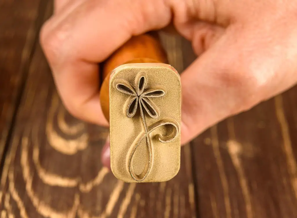 a simple hand-carved pottery stamp