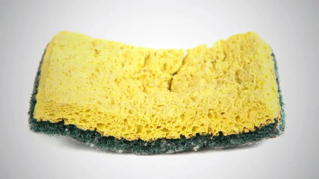 a yellow kitchen sponge highlighting stains and dirt