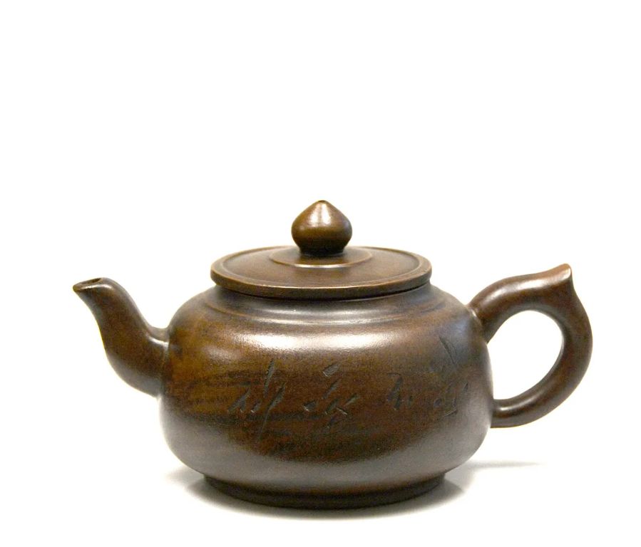 an antique chinese teapot made from purple clay