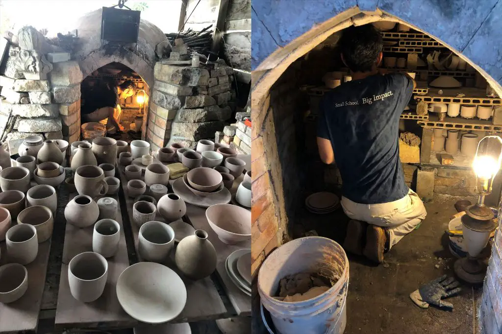 an artisan loading handcrafted pottery into a traditional wood-fired kiln to achieve unique glazing effects through exposure to flame and smoke