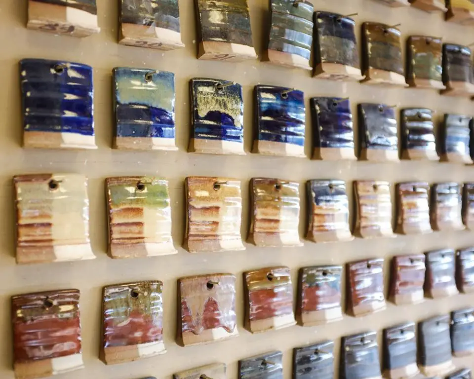 an assortment of glazes on a studio shelf