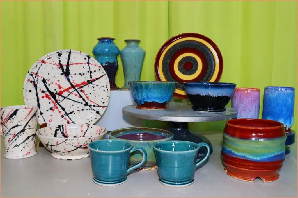 an assortment of handmade pottery pieces ready for sale.