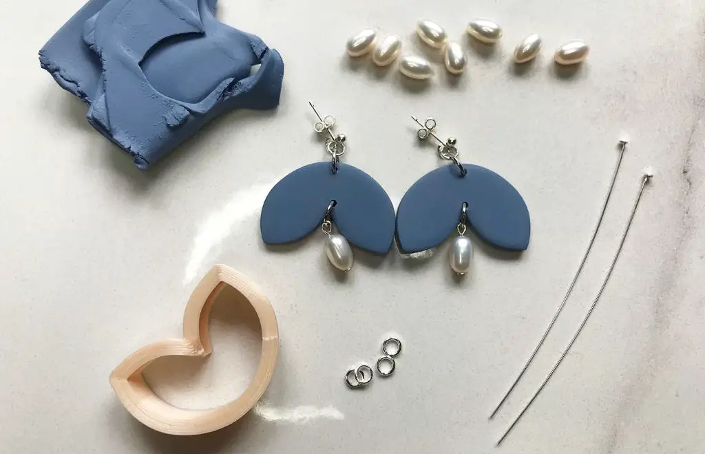 an assortment of jewelry findings like clasps, jump rings, pins, and eye hooks that can be used to assemble handmade polymer clay jewelry pieces.