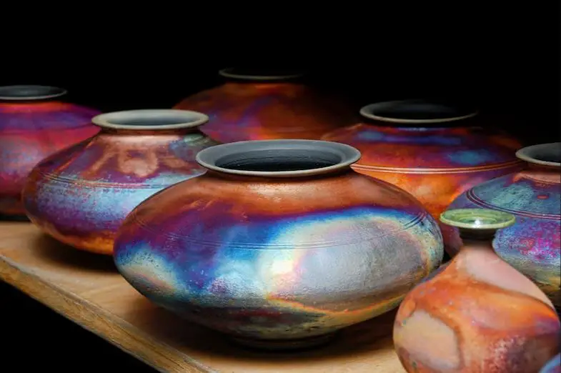 an example image of vibrant low-fire glazes in multiple colors on ceramic vessels and sculpture.