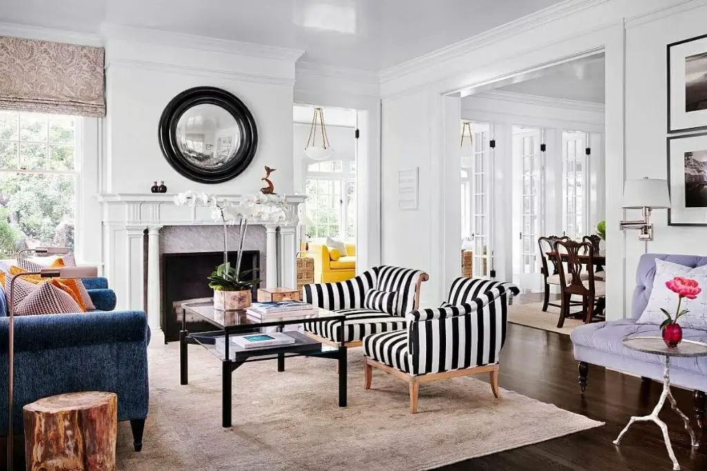 an image of a small living room with matching accent chairs and sofa