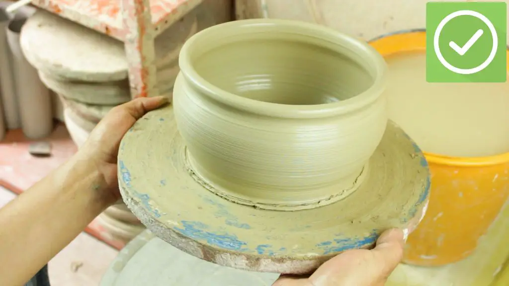 an indigenous woman building a clay pot using the coiling technique