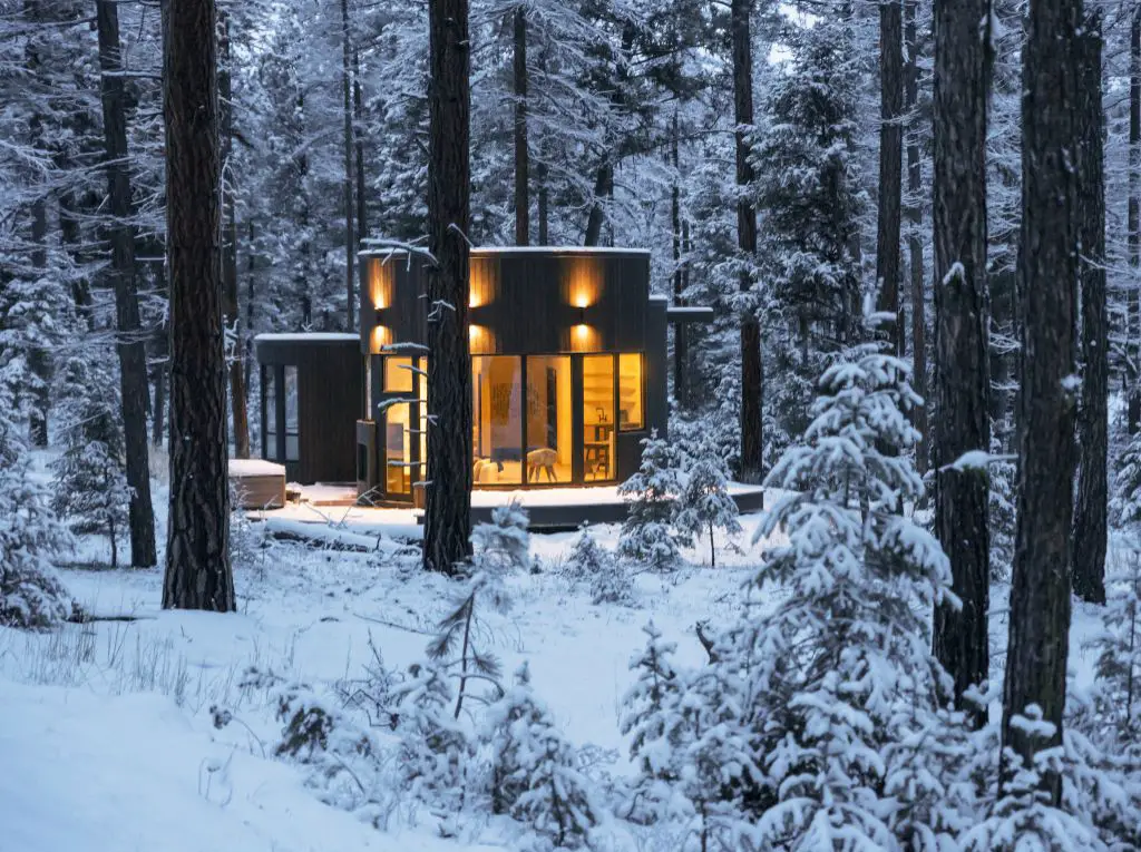 an old mansion deep in a snowy, magical winter wood setting