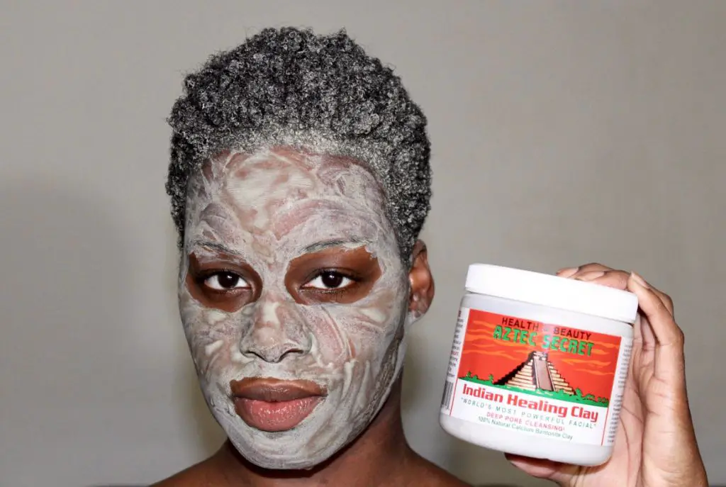 applying a calcium bentonite clay mask to clean skin