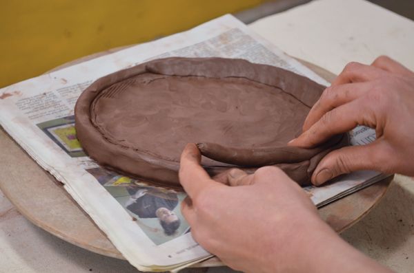 attach coils by smoothing seams to blend clay together