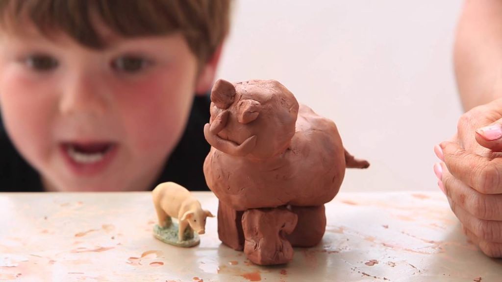 child sculpting with das clay