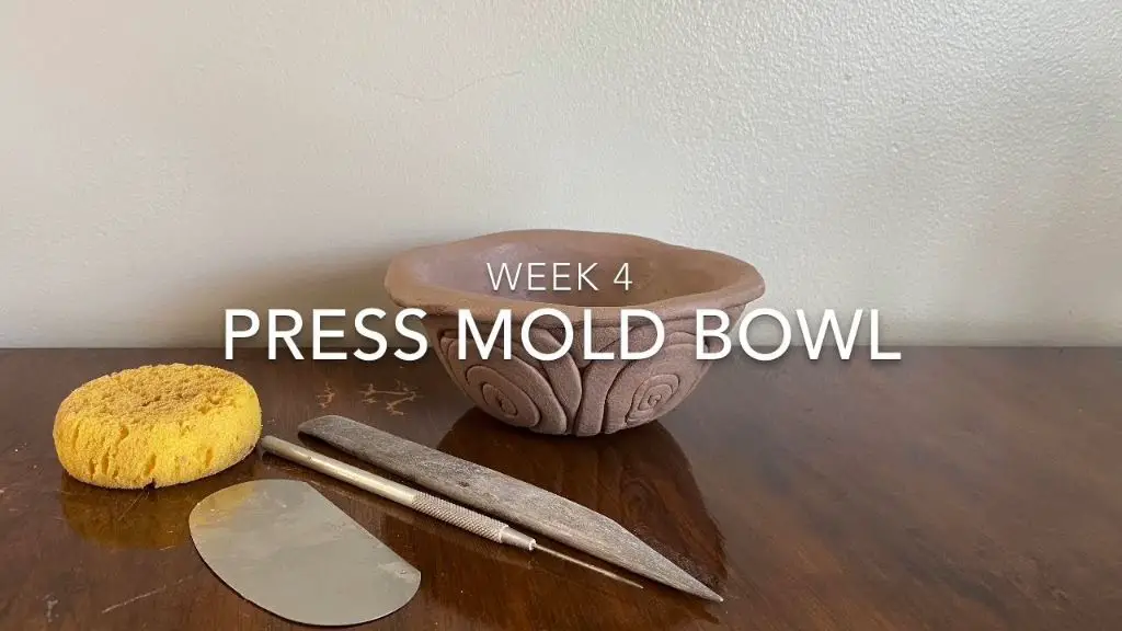 clay bowl pressed into a plastic bowl mold