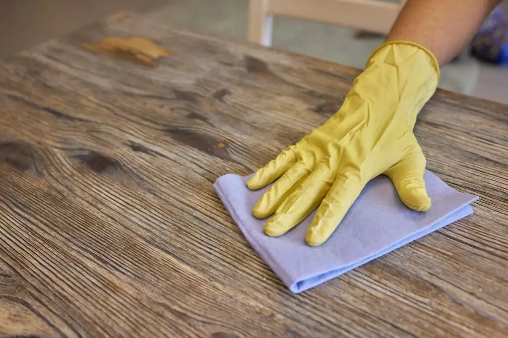 cleaning sanded wood with mineral spirits removes contaminants for optimal stain absorption