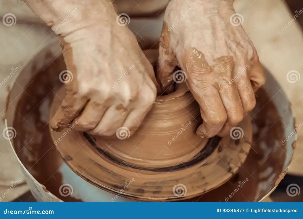 close up photo of potter's hands centering clay on a pacifica wheel head