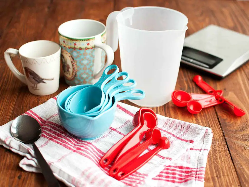 common household items like mugs, spoons, bottles, and bowls can substitute for measuring cups