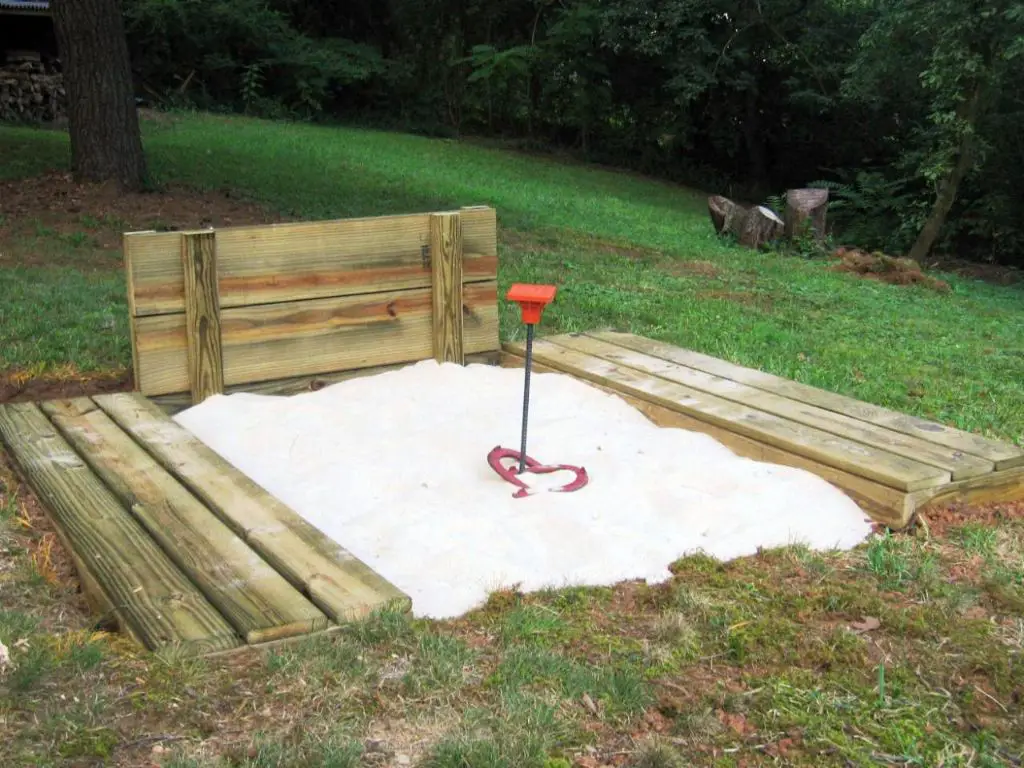 constructing a regulation horseshoe pit requires carefully following dimensions for stake spacing, pit size, and proper maintenance.