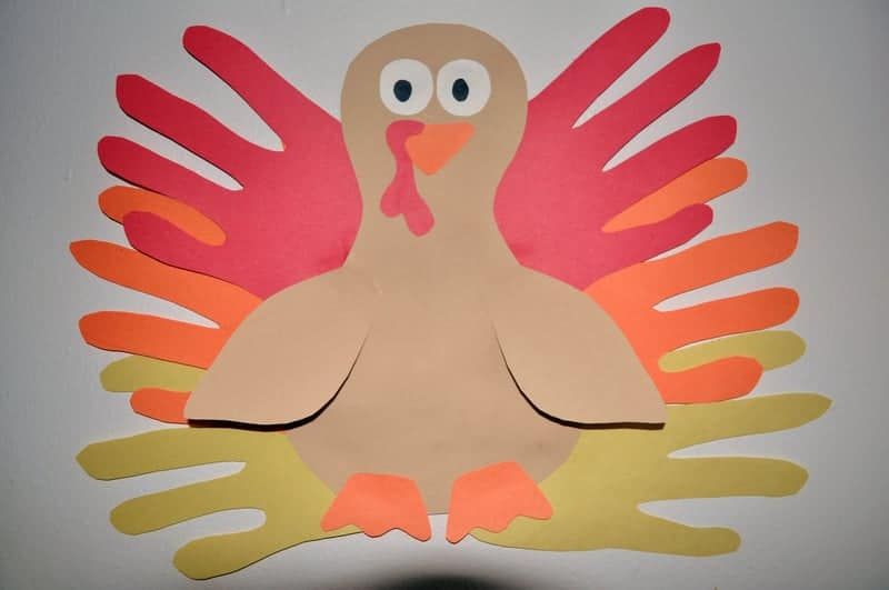 cutting out the traced hand turkey shape from construction paper