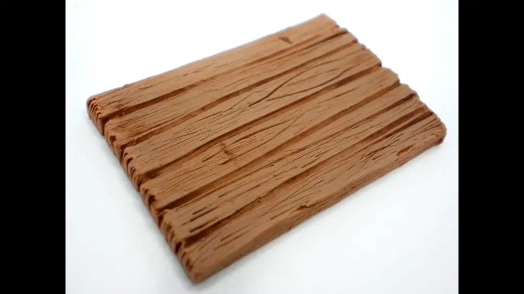 das clay sculpted into a wood plank with grain patterns