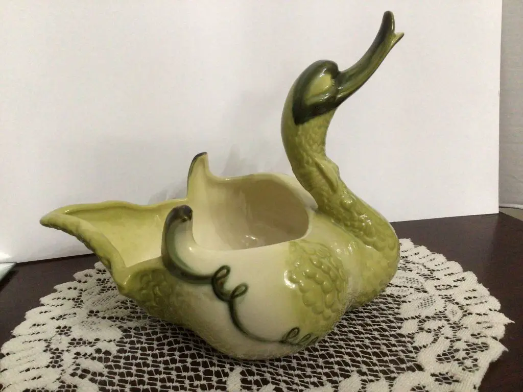 different brightly colored and glazed hull pottery pieces including swan and bird shaped vases