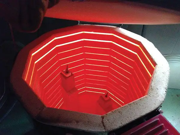 electric heating elements inside a kiln glowing red hot