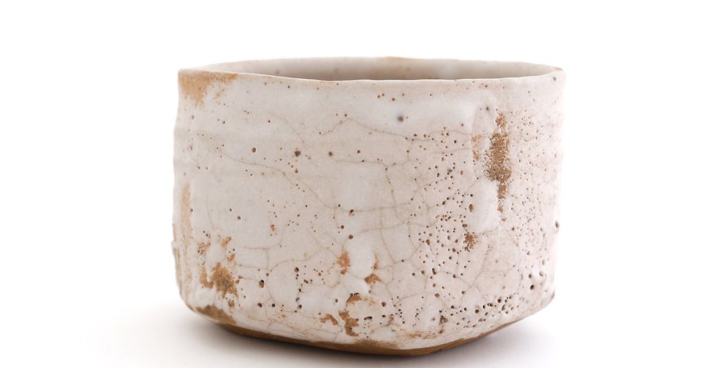 examples of shino glazed ceramic pieces showing the characteristic cracking patterns and textured surfaces.
