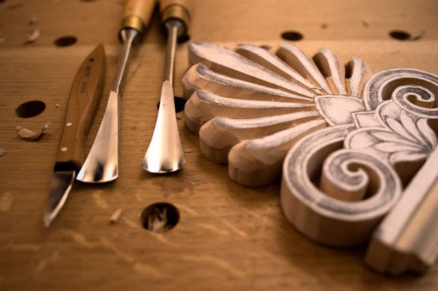 gouges with curved blades are essential wood carving tools for scooping out concave areas in a hand-carved stamp design.