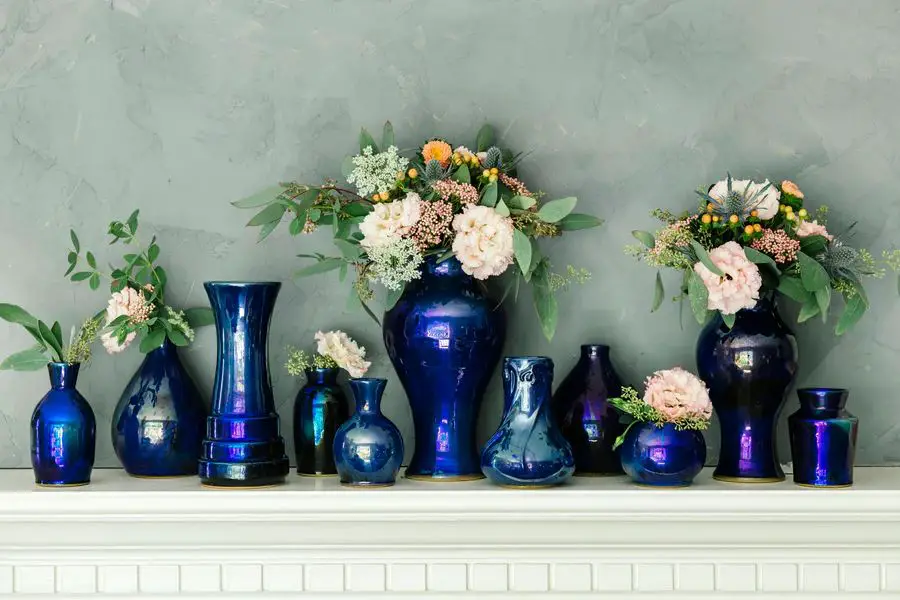 image showing examples of pewabic pottery pieces with nature-inspired designs like flowers, trees, and animals