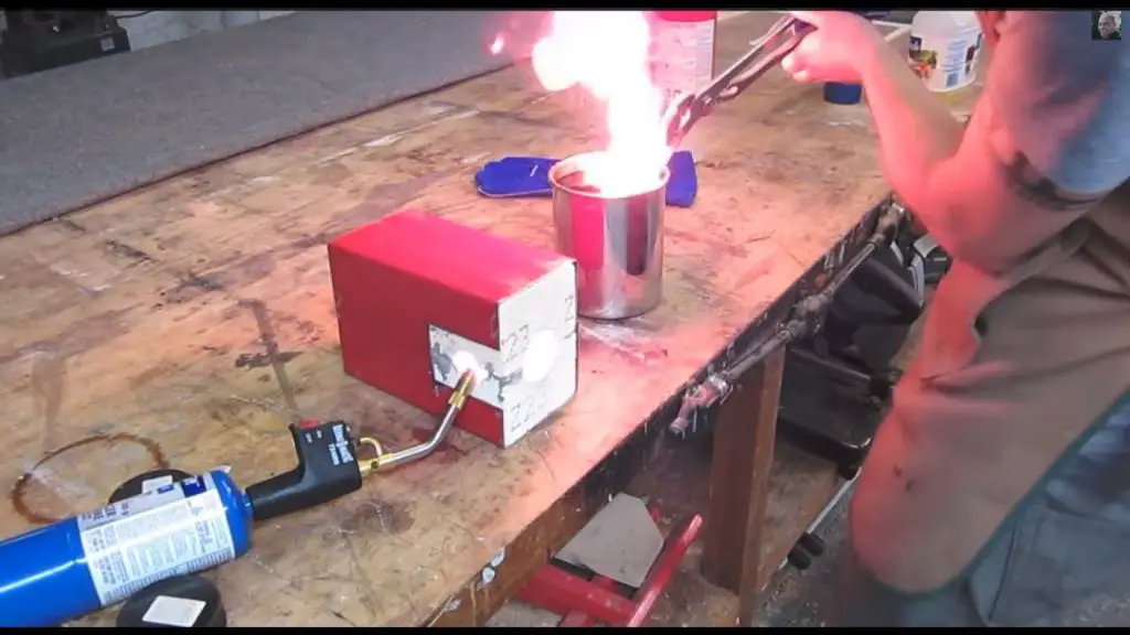 knife maker using torch to heat treat blade