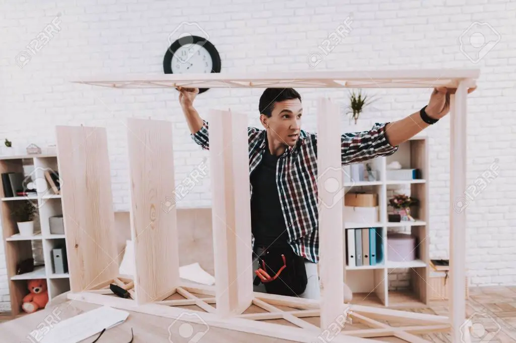 man building bookshelf