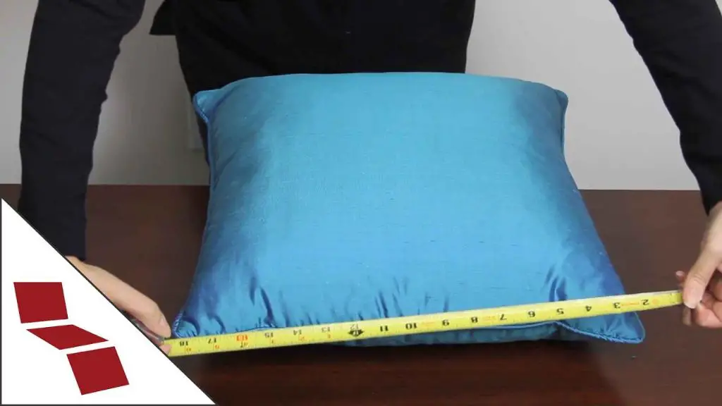 measuring a pillow with a cloth tape measure to get accurate dimensions for purchasing properly fitted pillowcases