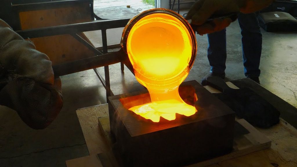 molten glass being poured into a mold to create a sculpture