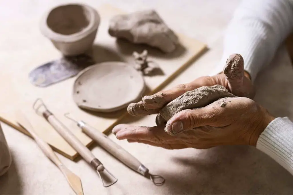 person bonding clay coils together