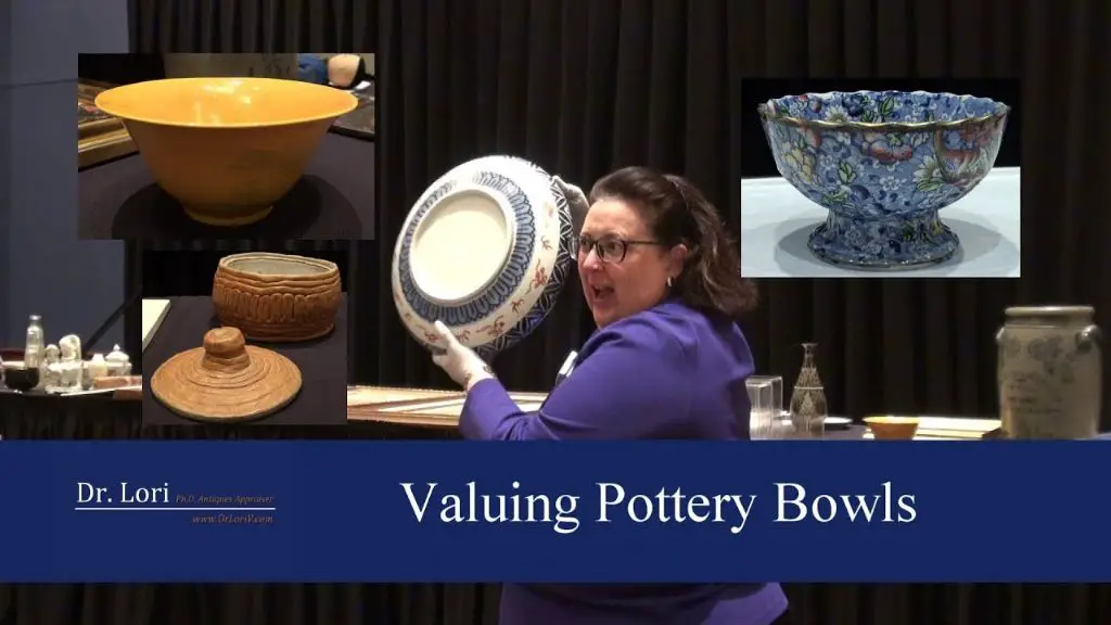 person examining an antique ceramic bowl