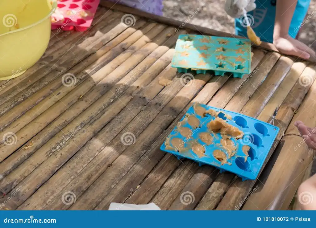 person pouring soap into a silicone mold