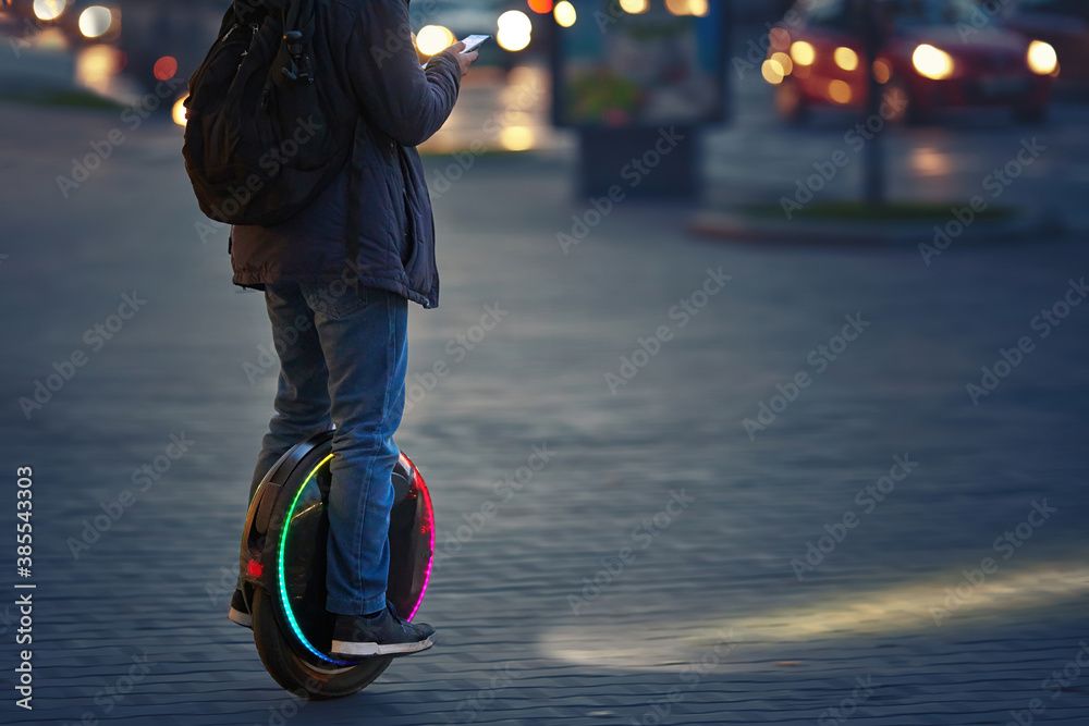 person riding electric unicycle on city street