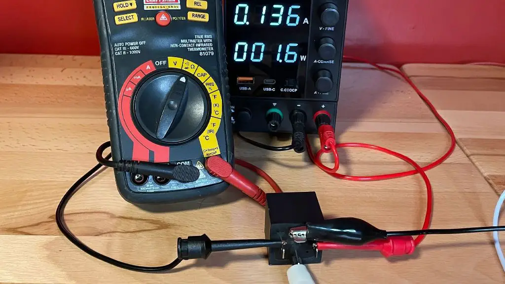 photo of an electrician using a multimeter to test a faulty power relay