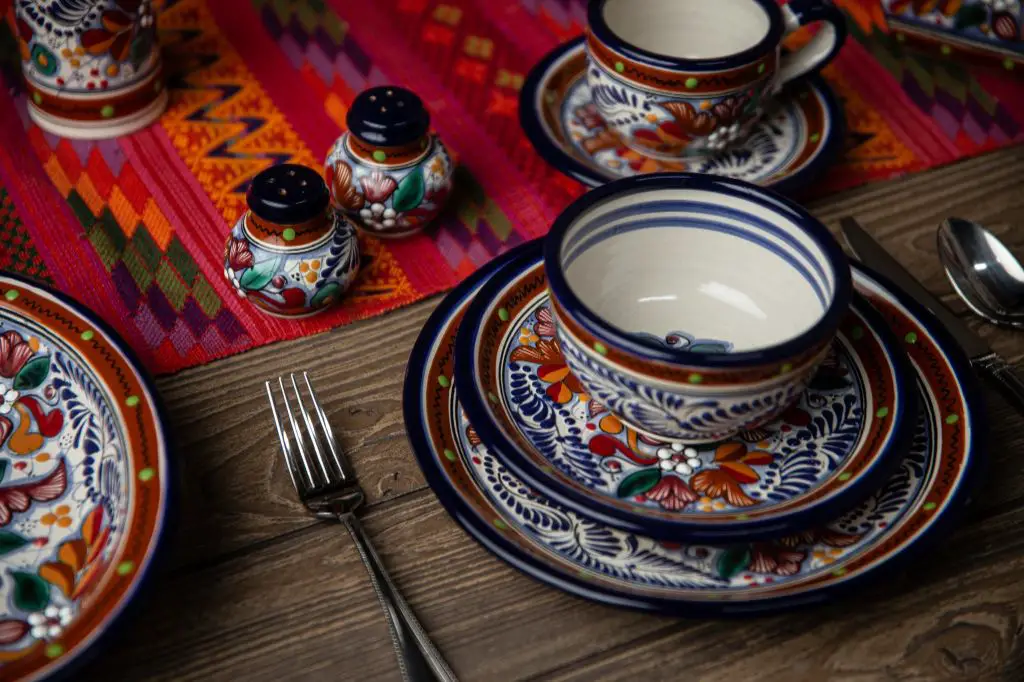 photo of vibrantly decorated majolica pottery pieces including plates, bowls, and pitchers